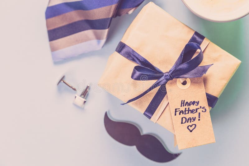 Fathers day concept - present, coffee, tie, mustache stock images