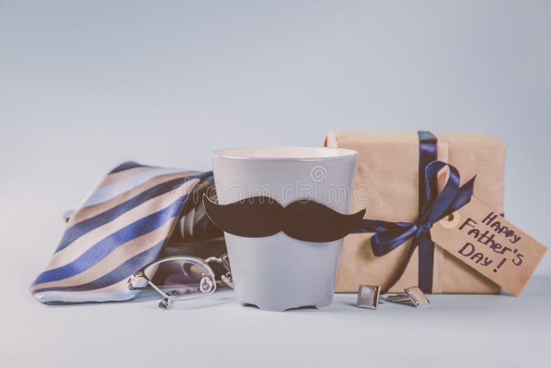 Fathers day concept - present, coffee, tie, mustache stock photography