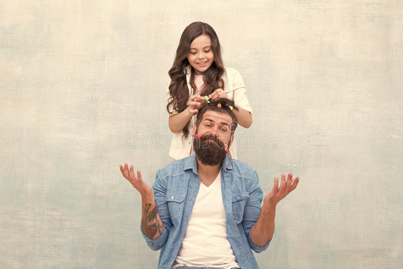 Fathers day with daughter at home. Daughter creating fathers hair. Handsome father with little girl. Happy father and