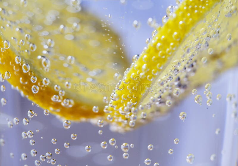 Lemon Slices in Clear Soda Water with Bubbles in the Background. Lemon Slices in Clear Soda Water with Bubbles in the Background