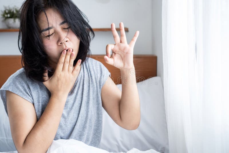 morning fatigue, waking up tired concept with Asian woman doesn't feel refreshed after sleeping. morning fatigue, waking up tired concept with Asian woman doesn't feel refreshed after sleeping