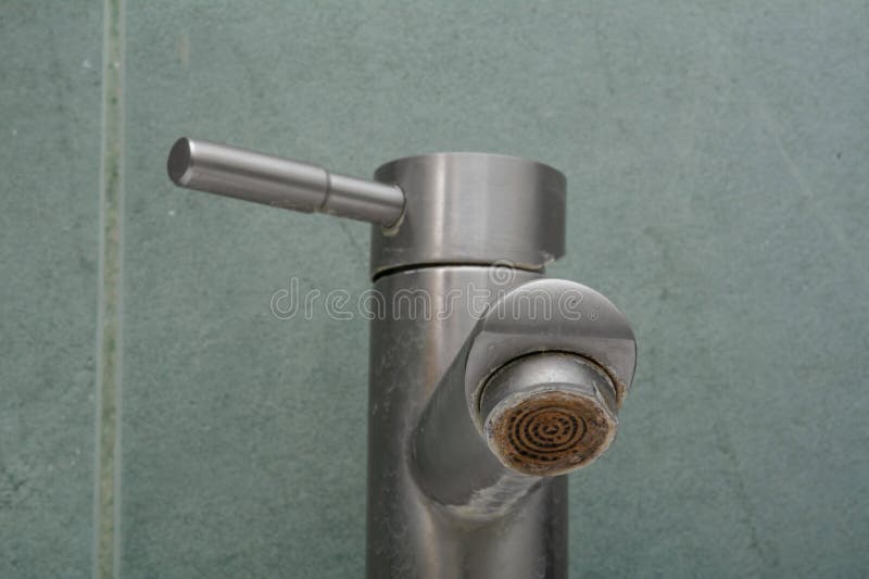 Faucet limescale. Dirty faucet aerator with limescale, calcified shower water tap with lime scale in bathroom, close up. Selective royalty free stock images