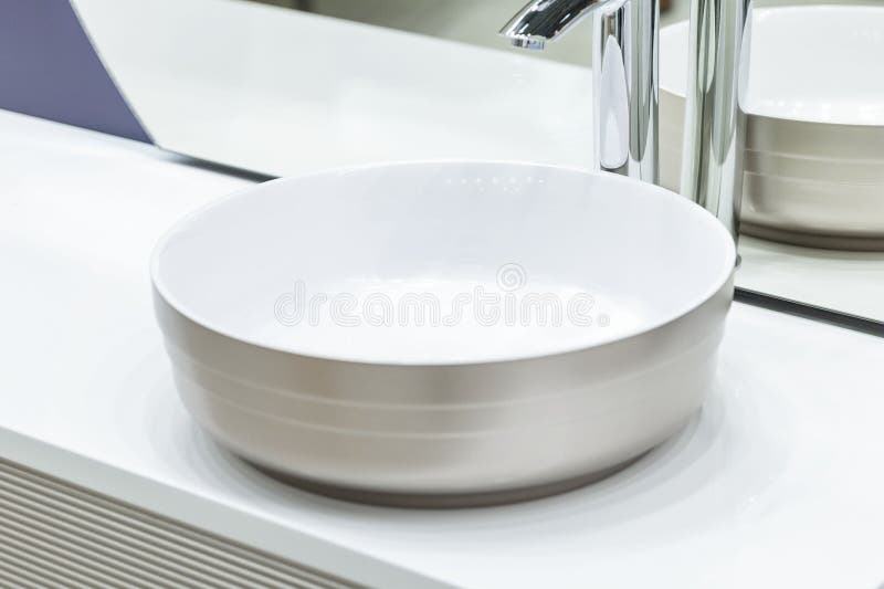 Faucet for Water Over a White Sink. Closeup. Selective Focus Stock