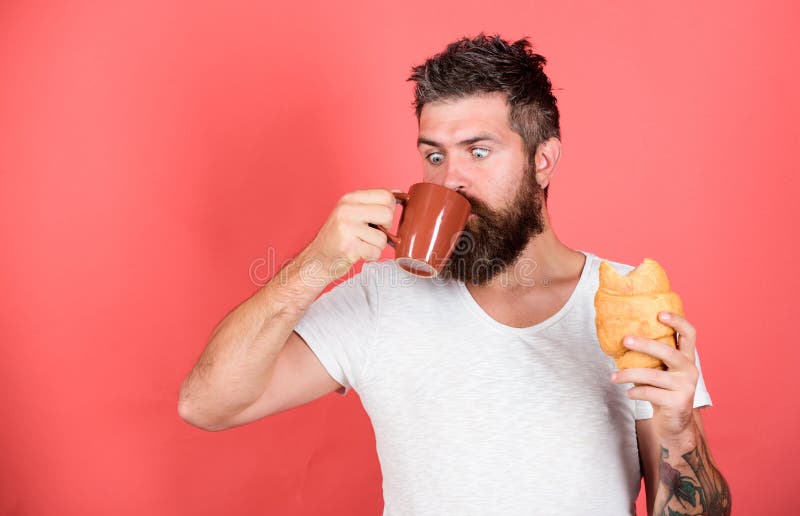 Favorite breakfast. Bearded hipster enjoy breakfast drink coffee. Morning tradition concept. Fresh baked croissant royalty free stock photos Favorite breakfast. Bearded hipster enjoy breakfast drink coffee. Morning tradition concept. Fresh baked croissant royalty free stock photos