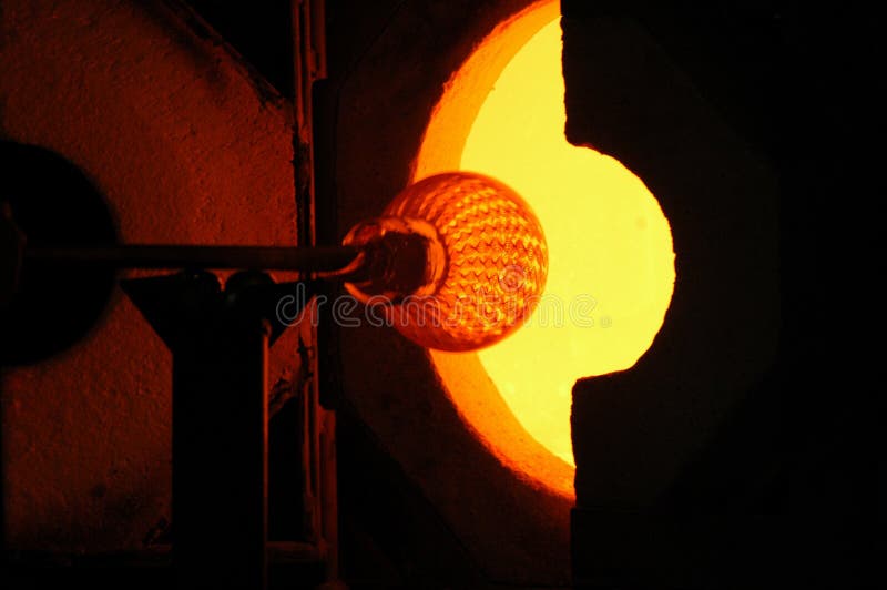 A half-made vase is placed into a kiln to make the glass soft. A half-made vase is placed into a kiln to make the glass soft.