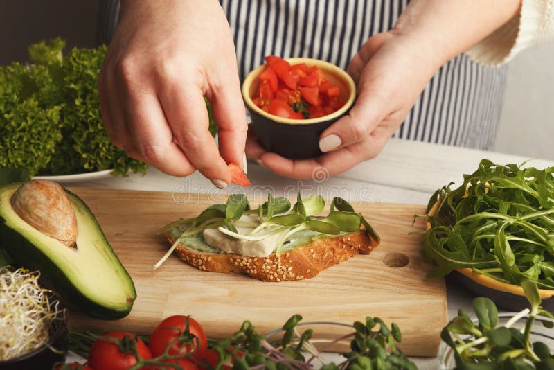 Feamale hands making healthy bruschettas for right snack