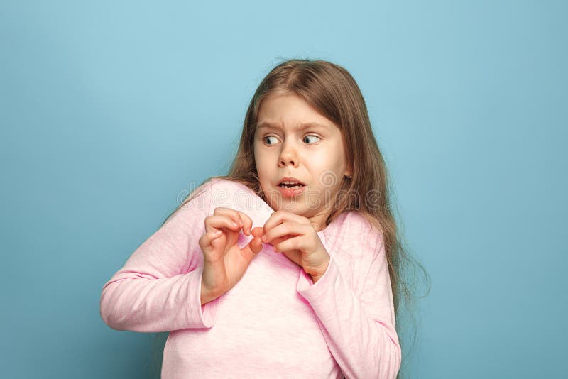 The fear. Teen girl on a blue background. Facial expressions and people emotions concept stock photos The fear. Teen girl on a blue background. Facial expressions and people emotions concept stock photos