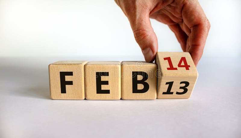 February 14 valentines day symbol. Hand turns the cube and changes the word 'Feb 13' to 'Feb 14'. Beautiful white background  copy space. February 14 Valentines day concept. February 14 valentines day symbol. Hand turns the cube and changes the word 'Feb 13' to 'Feb 14'. Beautiful white background  copy space. February 14 Valentines day concept