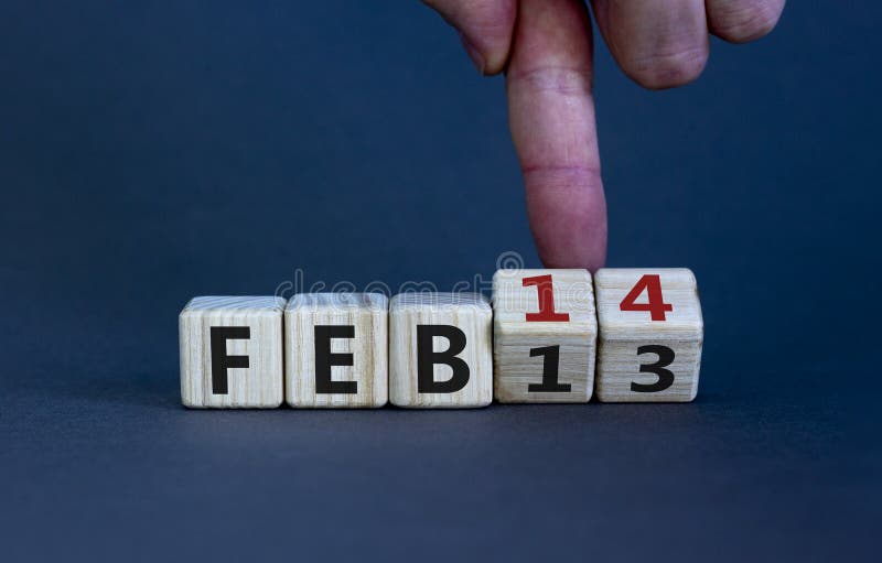 February 14 valentines day symbol. Hand turns cubes and changes the word 'Feb 13' to 'Feb 14'. Beautiful grey background  copy space. February 14 Valentines day concept. February 14 valentines day symbol. Hand turns cubes and changes the word 'Feb 13' to 'Feb 14'. Beautiful grey background  copy space. February 14 Valentines day concept