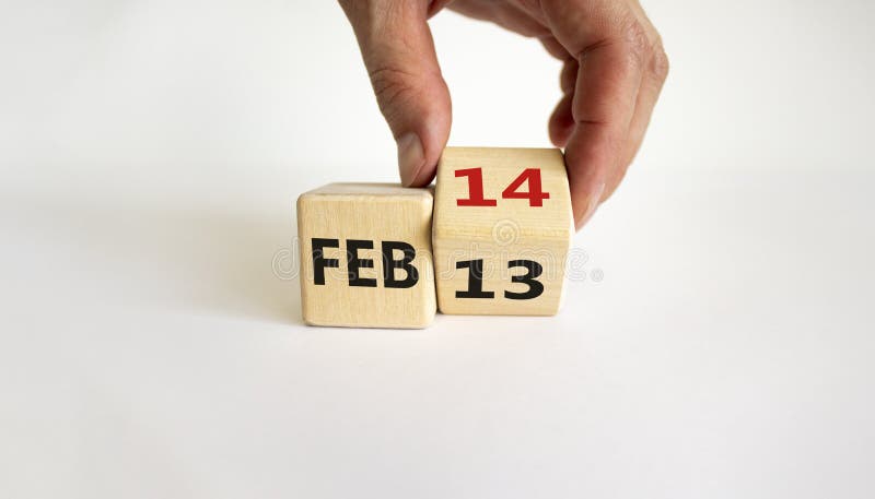 February 14 valentines day symbol. Hand turns the cube and changes the word `Feb 13` to `Feb 14`. Beautiful white background, copy space. February 14 Valentines day concept. February 14 valentines day symbol. Hand turns the cube and changes the word `Feb 13` to `Feb 14`. Beautiful white background, copy space. February 14 Valentines day concept.