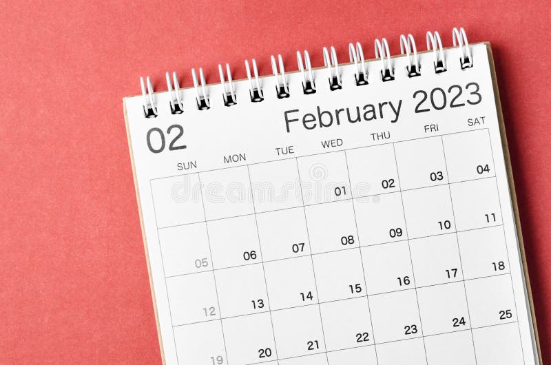 A February 2023 calendar desk for the organizer to plan and reminder isolated on red background