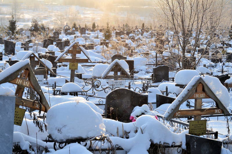Crosses in a cemetery, monuments of the dead, a cemetery in winter, wreaths, artificial flowers. Russia stock photo Crosses in a cemetery, monuments of the dead, a cemetery in winter, wreaths, artificial flowers. Russia stock photo