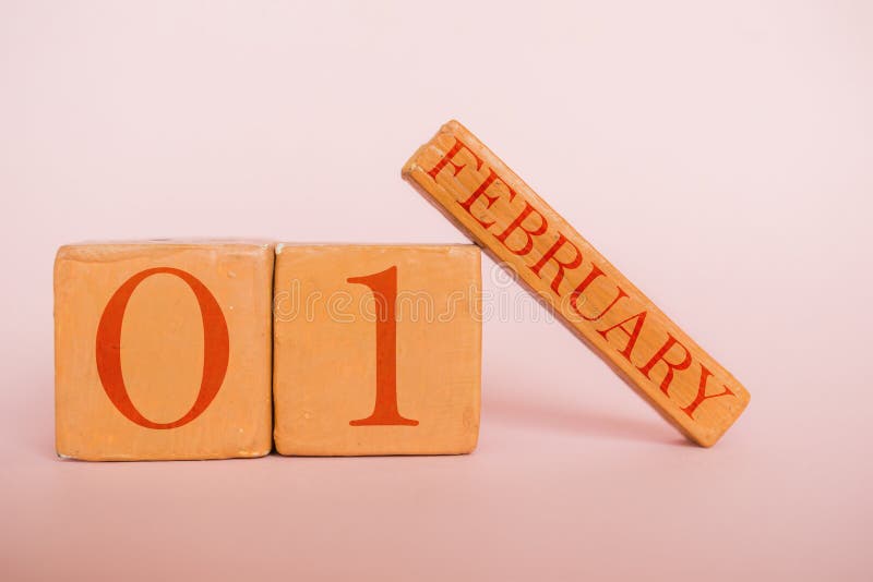 february 1st. Day 1 of month, handmade wood calendar  on modern color background. winter month, day of the year concept