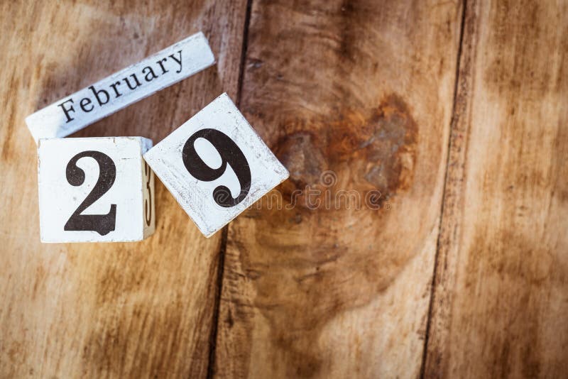 February 29th. Day 29 of February month, white calendar blocks on vintage wooden table background. Winter time. Empty space for