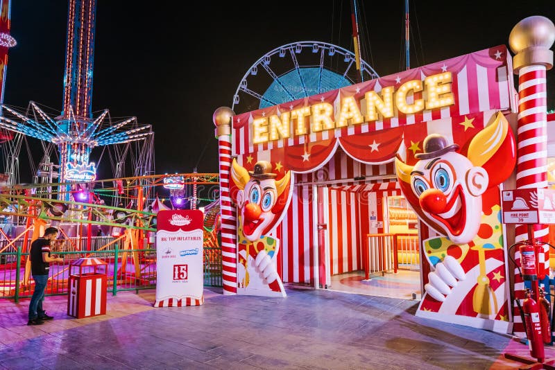 26 February 2021, UAE, Dubai: Entrance to the amusement park and child circus at funfair area of Global Village at night