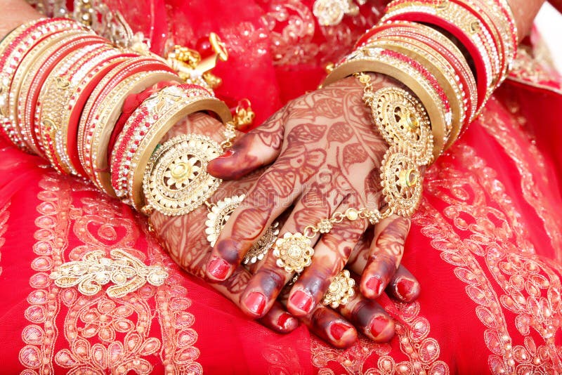 Close up of Decorative hands of Indian Bride with Golden Jewellery. Selective Focus is used. Close up of Decorative hands of Indian Bride with Golden Jewellery. Selective Focus is used.