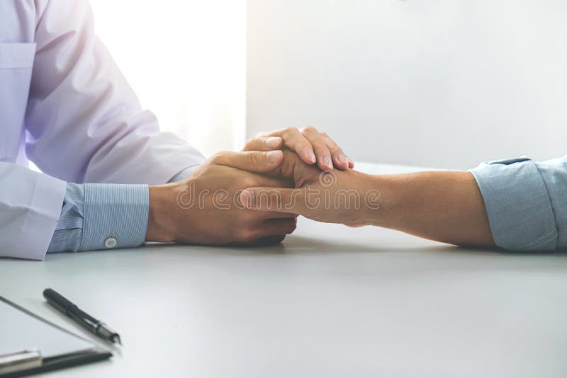 Close up of doctor touching patient hand for encouragement and empathy on the hospital, cheering and support patient, Bad news, medical examination, trust and ethics. Close up of doctor touching patient hand for encouragement and empathy on the hospital, cheering and support patient, Bad news, medical examination, trust and ethics