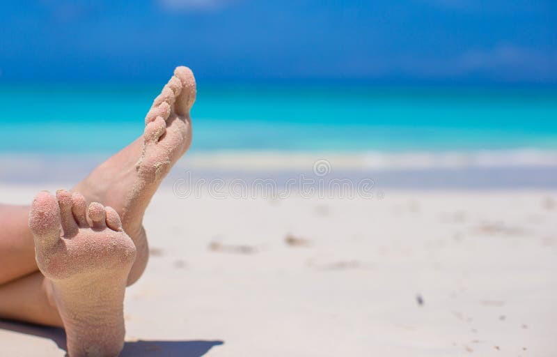 Feche acima dos pés fêmeas no Sandy Beach branco foto de stock Feche acima dos pés fêmeas no Sandy Beach branco foto de stock