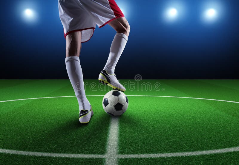 Feche um jogador de futebol pronto para chutar a bola no estádio imagens de stock royalty free Feche um jogador de futebol pronto para chutar a bola no estádio imagens de stock royalty free