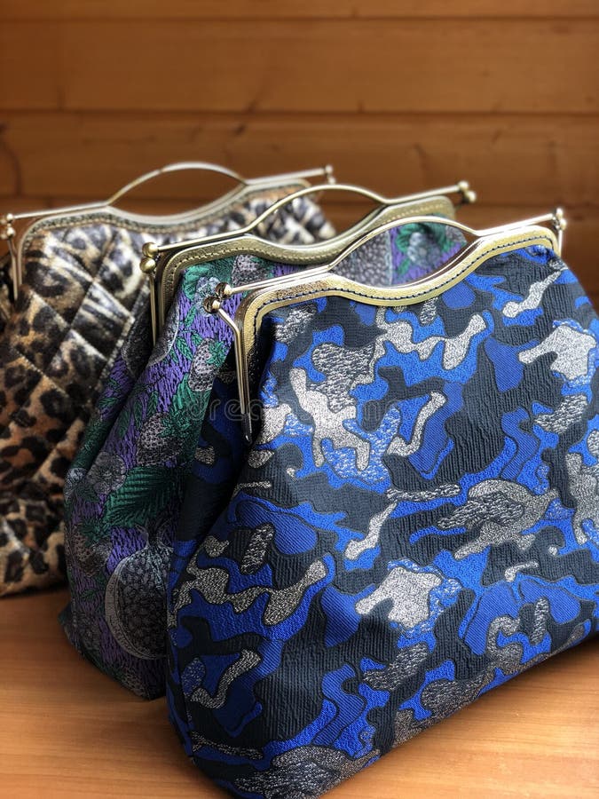 Three womens bags on the table. Travel bag. Fabric bag. Clasp bag. Three womens bags on the table. Travel bag. Fabric bag. Clasp bag