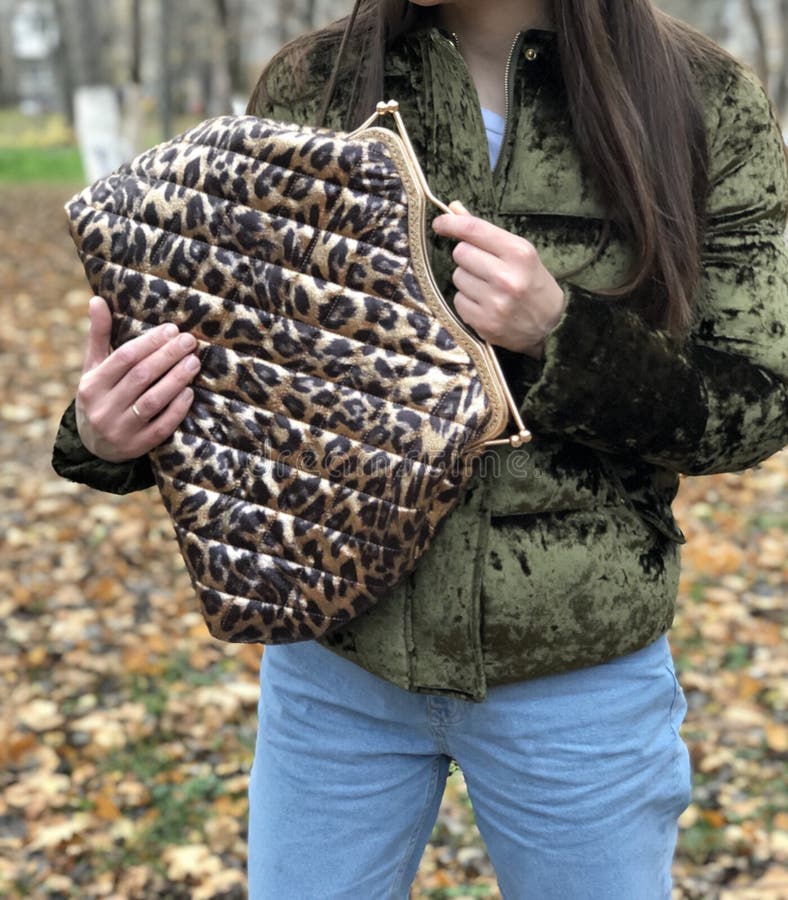 Three womens bags on the table. Travel bag. Fabric bag. Clasp bag.  habdbag.  fashionable image. leopard print. Gold hardware. Three womens bags on the table. Travel bag. Fabric bag. Clasp bag.  habdbag.  fashionable image. leopard print. Gold hardware.