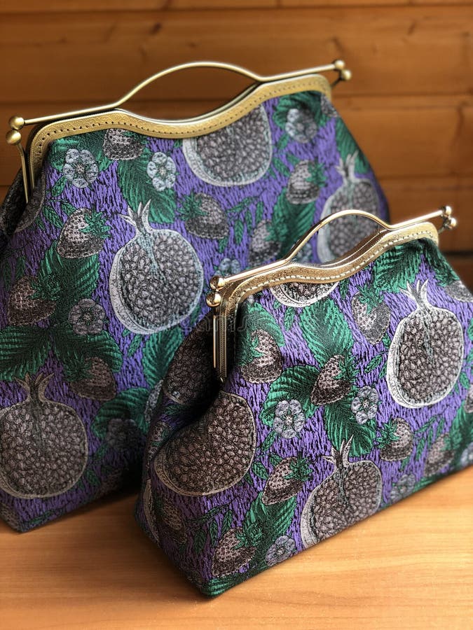 Three womens bags on the table. Travel bag. Fabric bag. Clasp bag. Big habdbag. Small clatch. Three womens bags on the table. Travel bag. Fabric bag. Clasp bag. Big habdbag. Small clatch.