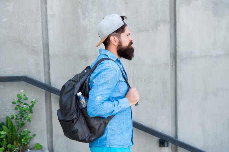 Feed your wanderlust. Mature hipster with beard traveller. Bearded man. Confident brutal man walk street. Male barber royalty free stock photo Feed your wanderlust. Mature hipster with beard traveller. Bearded man. Confident brutal man walk street. Male barber royalty free stock photo