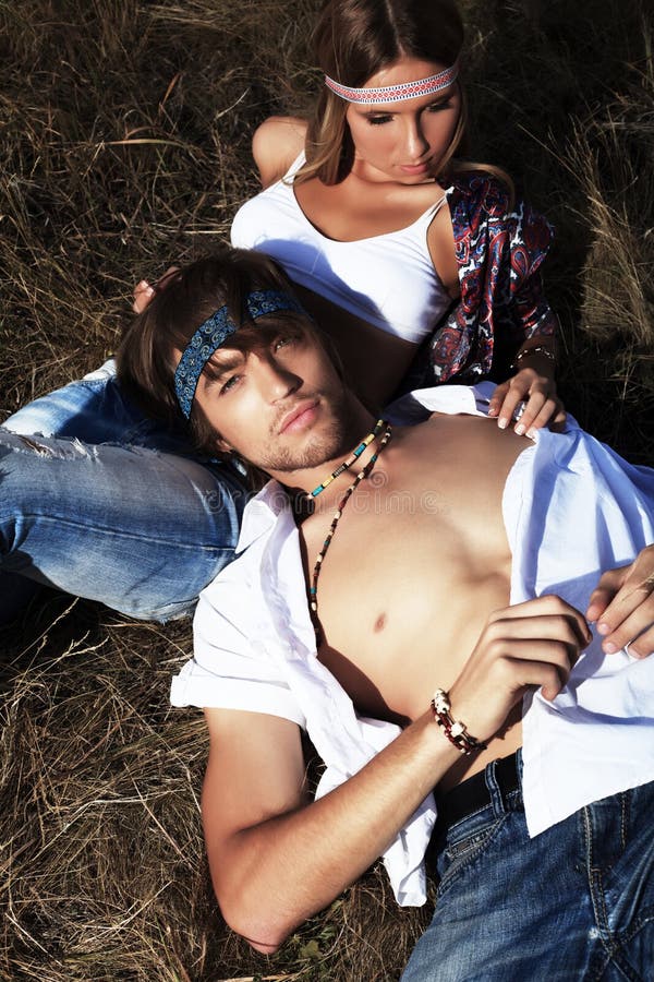 Beautiful young couple hippie posing together over picturesque landscape. Beautiful young couple hippie posing together over picturesque landscape.