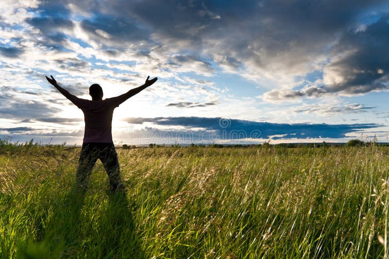 Feeling freedom. Man standing at the Sun. Feel Freedom only men.