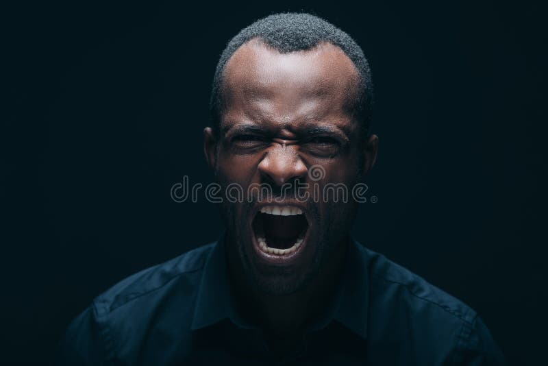 Studio Shot Of Angry Young Black African Man Screaming In Dark R Stock ...