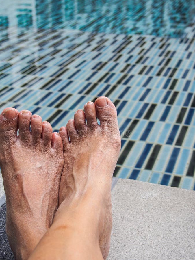 Feet On The Cement Floor Beside The Pool. Stock Image - Image of