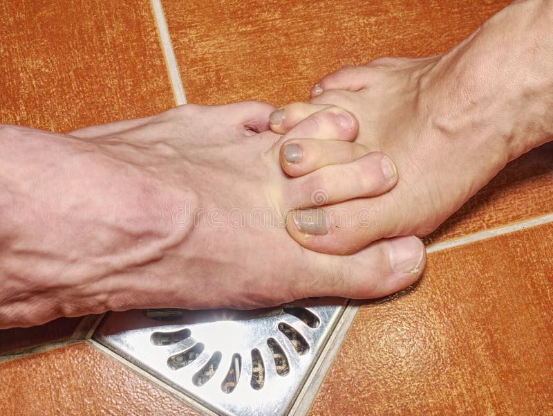 Feet of girlfriend and boyfriend in shower stall royalty free stock photography