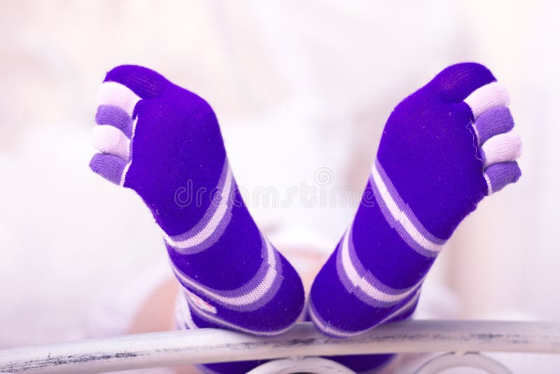 Feet girls in bright purple socks