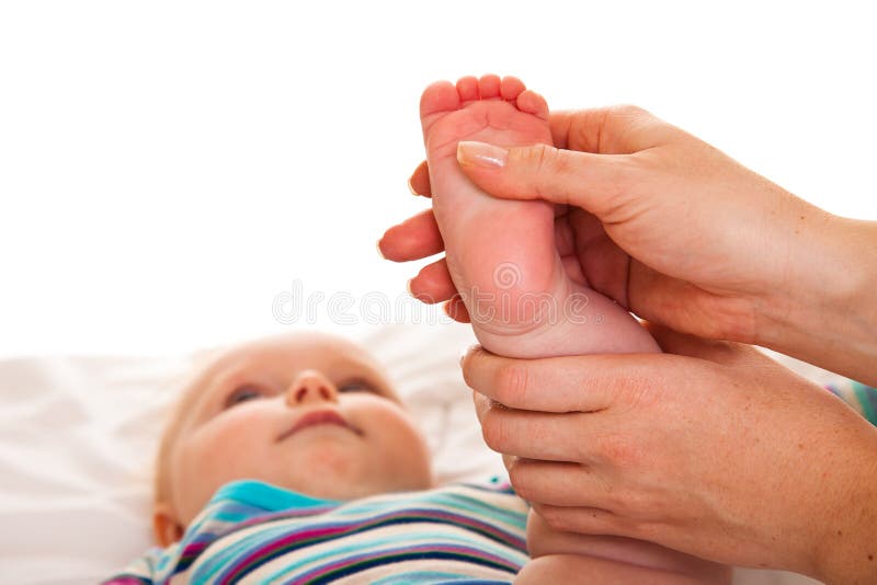 Feet massage of infant girl