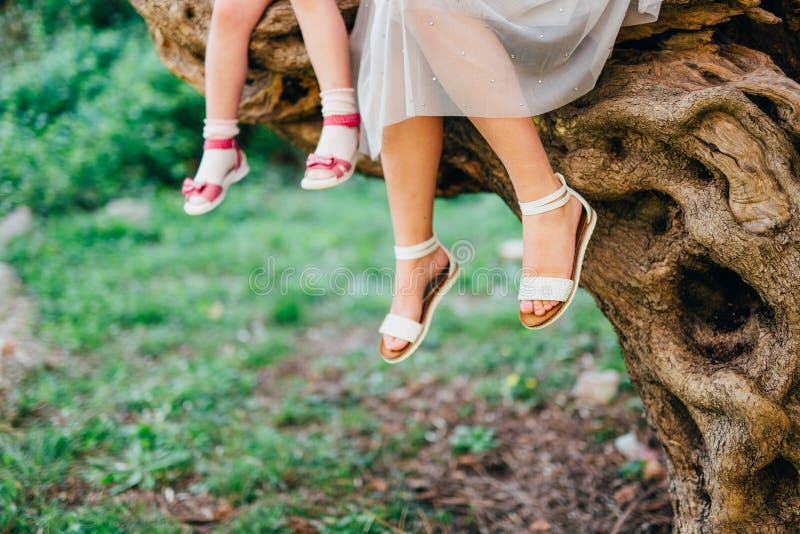 Feet of mother and child. My daughter and mother are sitting on