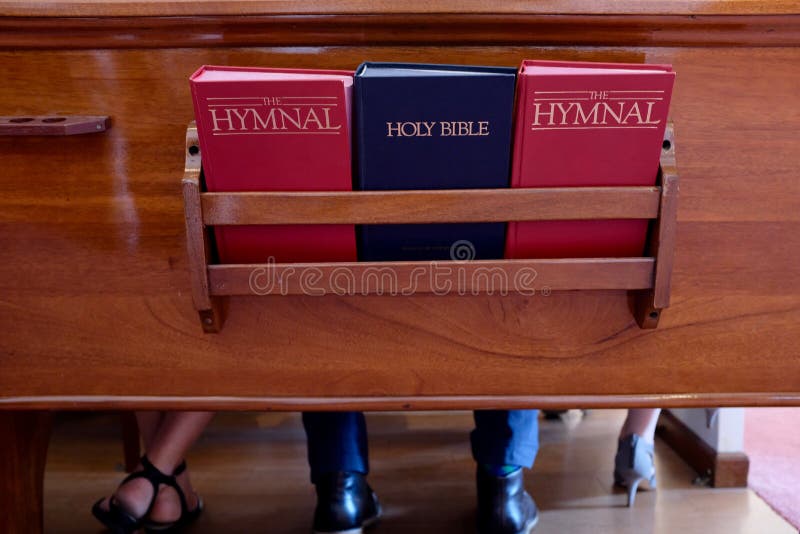 Church Pew With Bible and Hymnal Books