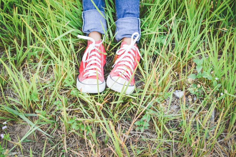 Feet Red Sneaker a Girl in Nature Stock Photo - Image of field, casual ...