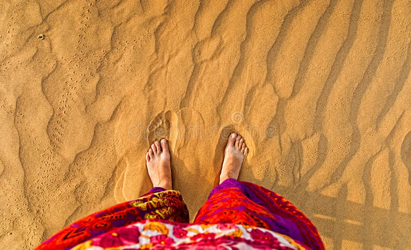 Feet in the sandy desert. stock image