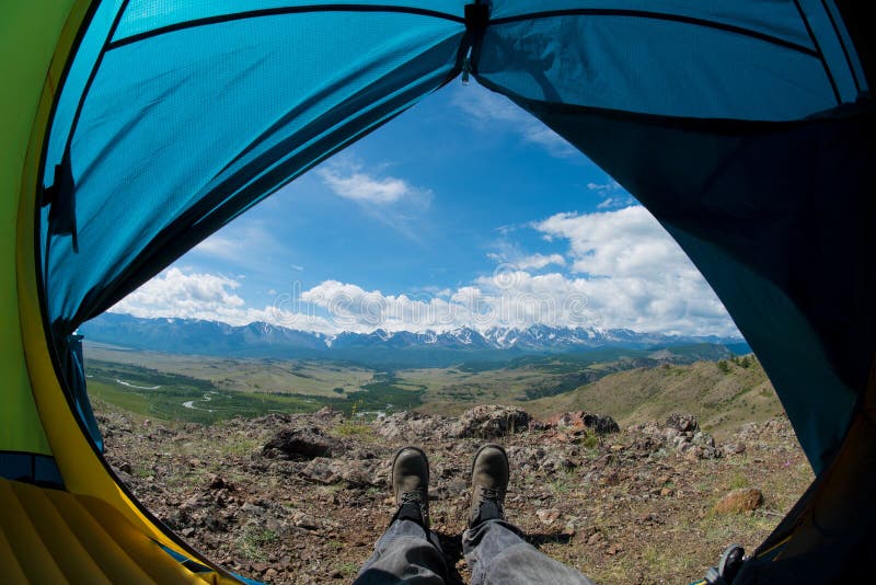 Feet in the Shoes Against the Backdrop of the Mountains Stock Photo