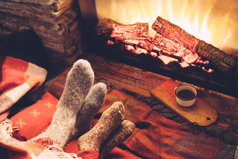 Feet in socks by the fire. Family, electric.