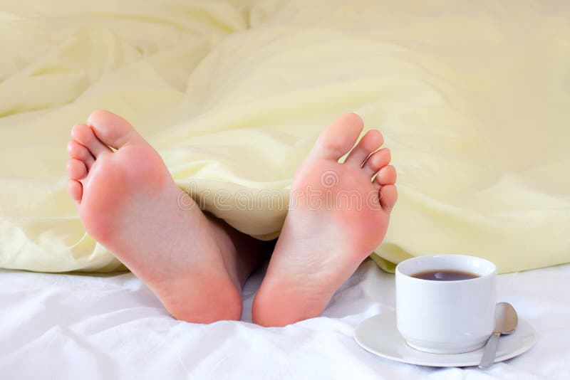 Feet under blanket stock photo. Image of people, pillow 13912412