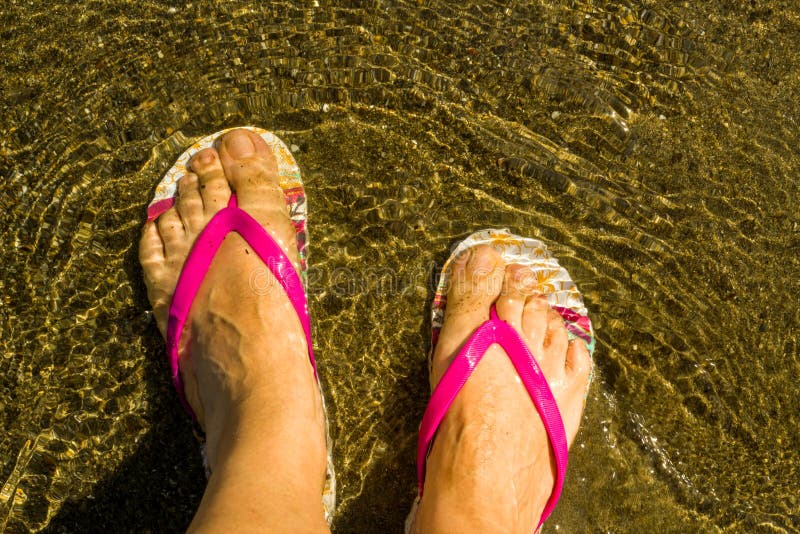 Feet of an Unknown Woman, Wearing Flip Flops, in Water, Stock Image ...