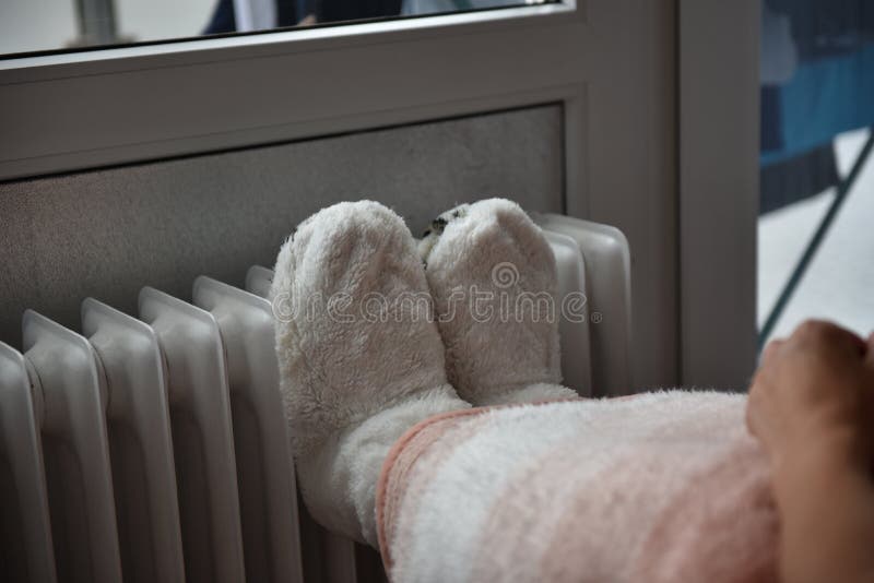 Feet in Warm Shoes on a Warm Heater Stock Photo Image of comfort, thermostat 255676334