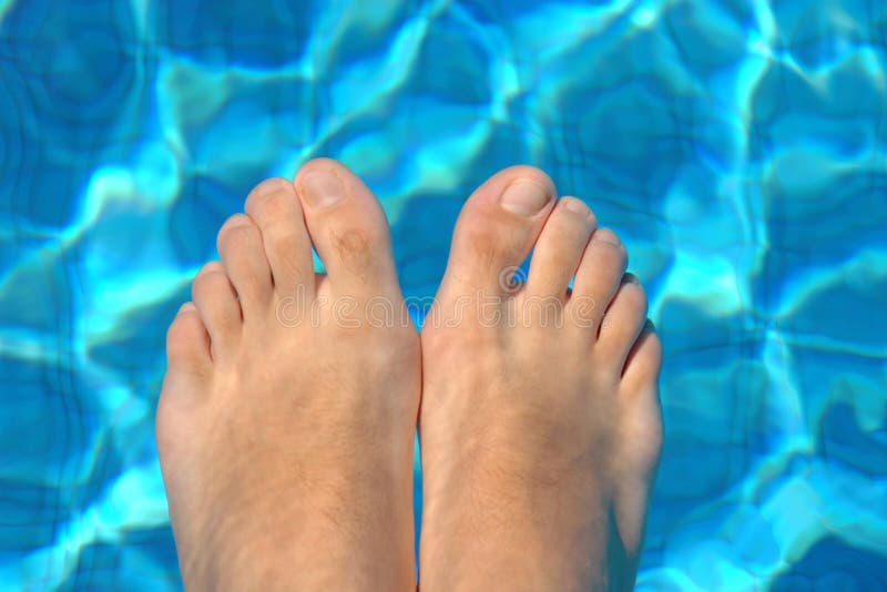 Feet in water on swimming pool