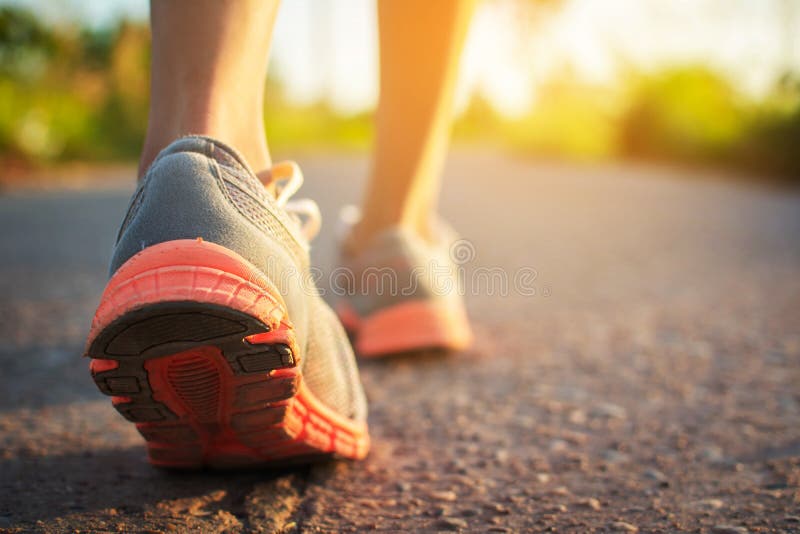 Feet of woman walking and exercise on the road