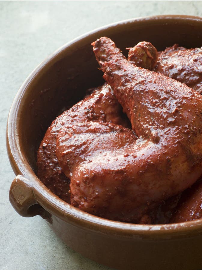 Dish of Chicken Legs Marinating in Tandoori Paste. Dish of Chicken Legs Marinating in Tandoori Paste