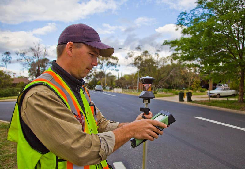 Surveyor checks his calculations before continuing his project. Surveyor checks his calculations before continuing his project