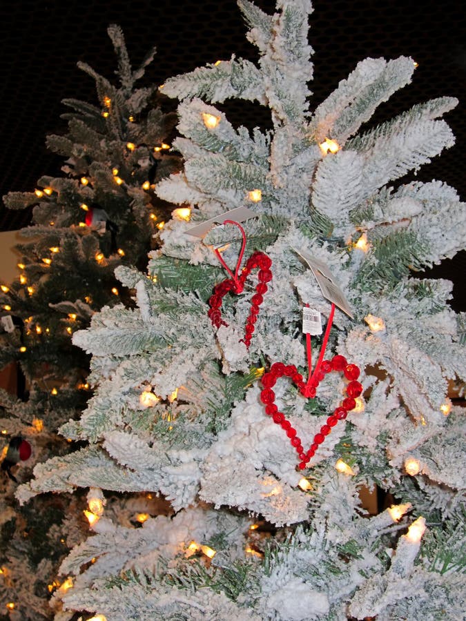 Happy new year. Decoration consists of two red hearts on the Christmas tree. Merry Christmas. Year of the rooster, cock, bantam. Christmas pattern 2017. St Valentines day background. Happy new year. Decoration consists of two red hearts on the Christmas tree. Merry Christmas. Year of the rooster, cock, bantam. Christmas pattern 2017. St Valentines day background.