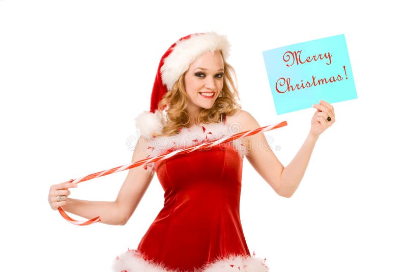 Blond sensual pinup woman in Christmas Mrs Santa Claus outfit holding sheet of paper with text Merry Christmas and points to it by huge candy cane stick. Can be used as greeting card or your text or additional graphics can be added according to needs. Blond sensual pinup woman in Christmas Mrs Santa Claus outfit holding sheet of paper with text Merry Christmas and points to it by huge candy cane stick. Can be used as greeting card or your text or additional graphics can be added according to needs.