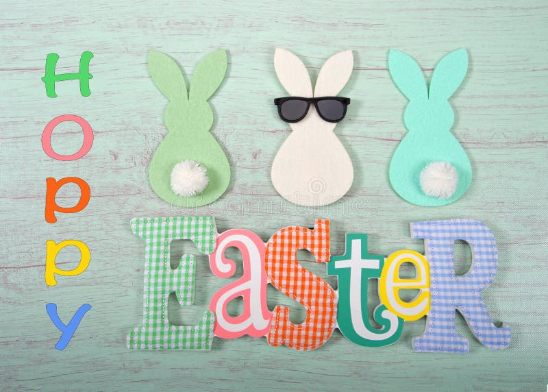 Felt bunnies in earth tone colors in a row Easter sign below royalty free stock photography Felt bunnies in earth tone colors in a row Easter sign below royalty free stock photography